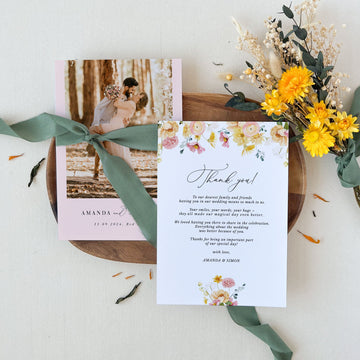 a wedding stationery with flowers and a thank card