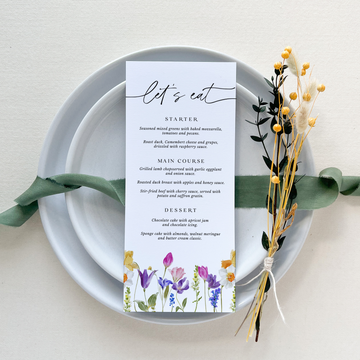 a place setting with a menu on a plate