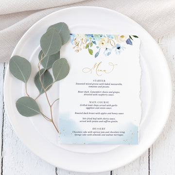 a white plate topped with a menu on top of a table